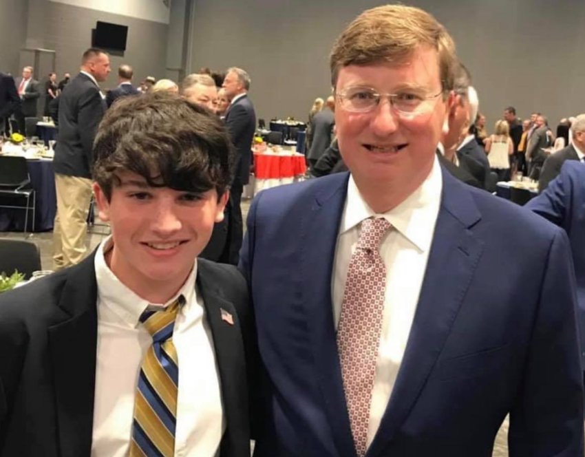 Ty Martin, left, chairman of the Neshoba County Teenage Republicans, with Gov. Tate Reeves.